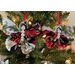 Photograph of two Christmas themed butterfly ornaments hung from a Christmas tree