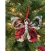 Photograph of one Christmas themed butterfly ornament hung from a Christmas tree