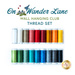Photo of a rainbow of thread on spools, isolated on a white background with the words 