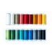 Photo of a rainbow of thread on spools, isolated on a white background