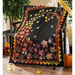 Autumn Allure fall quilt styled on black bench