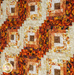 Close up of the log cabin throw quilt made with orange, brown, and cream fabrics showing the log cabin block pattern and fabric details