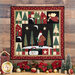 Photo of the Santa Claus Lane wall hanging on a dark paneled wall with winter poinsettia and ornament decorations.
