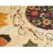 Close up photo of embroidery detail on an autumn-themed table topper