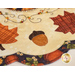 Close up photo of an applique acorn and embroidery detail on an autumn-themed table topper