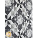 Close up photo of a black, white, and gray geometric quilt with floral patterns in the fabrics