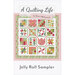 Front cover of Jelly Roll Sampler pattern from A Quilting Life, 12 blocks in a 4x4 layout of bright, cheery, springtime motifs, as well as pinwheels and stars,