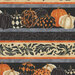 close of scan of fabric featuring rows of various painted pumpkins between stripes of muted orange and gray, alongside additional stripes of cream with black filigree and black with tonal damask-inspired patterning