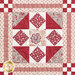 Close up photo of one block of the patchwork quilt made with red and cream floral fabrics