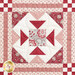 Close up photo of one block of the patchwork quilt made with red and cream floral fabrics