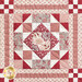 Close up photo of one block of the patchwork quilt made with red and cream floral fabrics