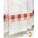 Close up photo of the bottom of a white kitchen towel with gingham fabric details