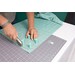 turquoise fabric being cut using SewTites Sew Magnetic Cutting System