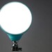 LED lamp in turquoise on grey background 