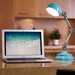 turquoise LED lamp on a counter with a laptop