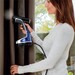 woman using handheld steamer to steam drapes