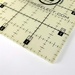 detailed view of an 18 inch square ruler with measurements going both directions 