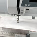 A wider shot of the sewing machine and slider in action