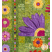 Close up photo of a floral quilt showing applique details of large pink, purple and orange daisies with a patchwork green background