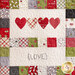 Close up of one block in the Hometown Christmas quilt featuring a row of 4 hearts and the word 