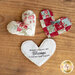 Three different assembled patchwork heart pocket prayer quilts on a wooden table