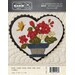 Front of pattern with finished heart featuring a woolen flowers in a pot with a visiting butterfly friend