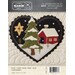 Front of pattern with finished heart featuring a red home with a snowy tree outside and a christmas star in the night sky