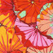 close up of Fabric featuring vibrant pink, red, yellow, and mint green overlapping lotus leaves