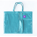 Image of the front of the teal tote, showing three vinyl pockets and one long cloth pocket