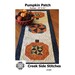 Front of pattern showing the completed table runner staged with a bowl of pinecones and autumn gourds