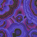 Close up of Fabric featuring vibrant blue, black, and purple agate designs over a swirling purple background