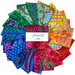 Photo of a rainbow of coordinating fabrics from the Kaffe Fassett Collective Plus collection fanned out in a circle