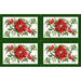 Fabric placemats featuring cardinals, poinsettias, and holly in the greens and reds of Christmas.