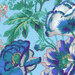 close up of Fabric featuring vibrant white, teal, blue, and yellow poppies over a light blue background