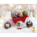 Photo of a small red sleigh table decor filled with wool felt ornaments amid winter decorations with 3 more ornaments in the foreground