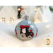 Photo of a wool felt ornament featuring a small steam engine with Santa's head in one window, surrounded by white Christmas and winter decor.