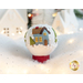 Photo of a wool felt snow globe featuring a small house in a snowy scene, surrounded by white Christmas and winter decor.
