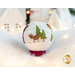 Photo of a wool felt snow globe featuring a small reindeer and 2 evergreen trees in a snowy scene, surrounded by white Christmas and winter decor.