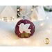 Photo of a wool felt ornament featuring a white dove carrying holly leaves, surrounded by white Christmas and winter decor.