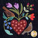 Close up of one quilt block showing a polka dotted heart with flowers growing out of the top with two songbirds perched nearby.