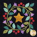 Close up of one quilt block showing a star surrounded by a wreath of flowers