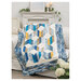 Sample quilt, geometric shapes in blues and golden yellows, draped over a couch