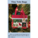 Pattern cover of Tiny patchwork fabric tote displayed on Christmas tree