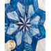 Close up photo of the center of the completed quilt block featuring a pinwheel shaped snowflake made with different shades of blue fabric with a white background.