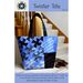 Front cover of pattern showing the completed tote in blue, staged on carpeted stairs