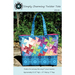 Front of pattern showing the finished tote in blue and the pinwheels in jewel tones