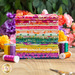 A Wild Abandon 28 FQ Set surrounded by colorful threads and florals.