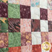 close up photo of a quilt made with natural colors in a woven pattern showing fabric detail
