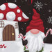 Close up of fabric panel featuring a mushroom house and Christmas gnome