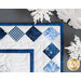 A close up photo of the square on-point border of the runner, staged with snowflake decor.